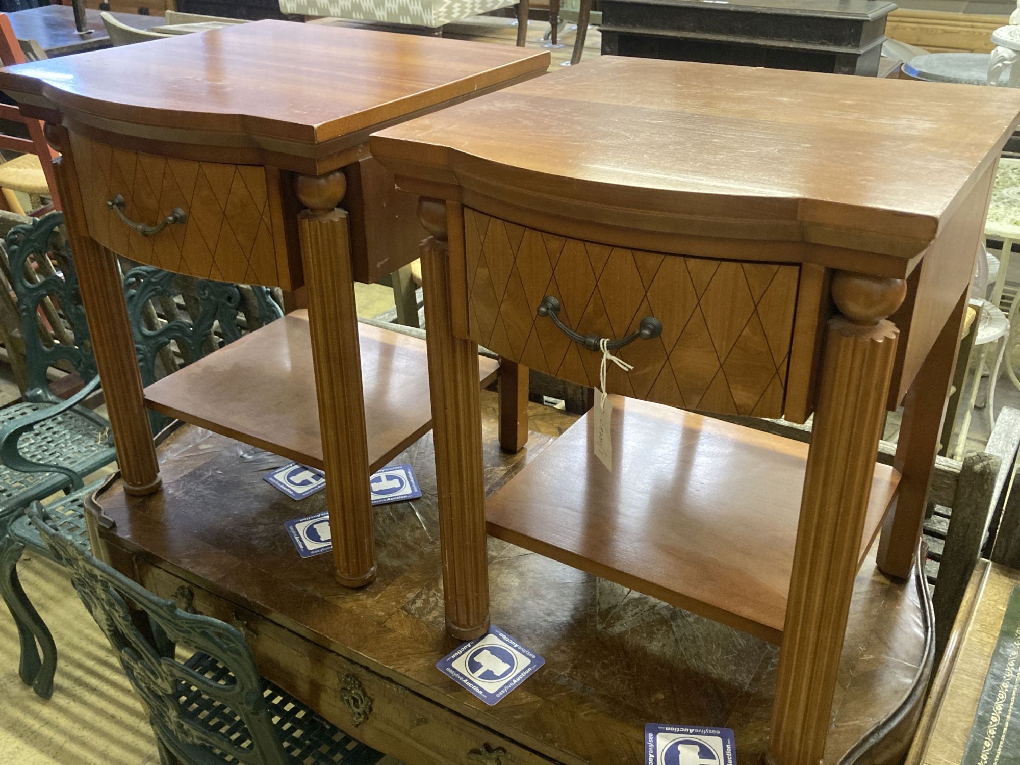 A pair of walnut bowfront two tier bedside tables, width 50cm, depth 50cm, height 61cm